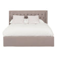 Grey upholstered king bed with a tufted headboard, featuring a plush white comforter and two decorative pillows. The bed has a spacious ottoman base for additional storage