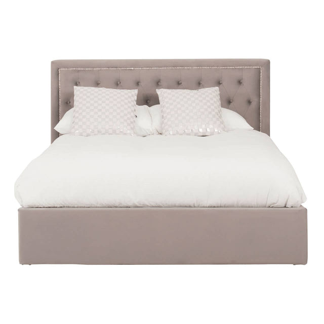 Grey upholstered king bed with a tufted headboard, featuring a plush white comforter and two decorative pillows. The bed has a spacious ottoman base for additional storage