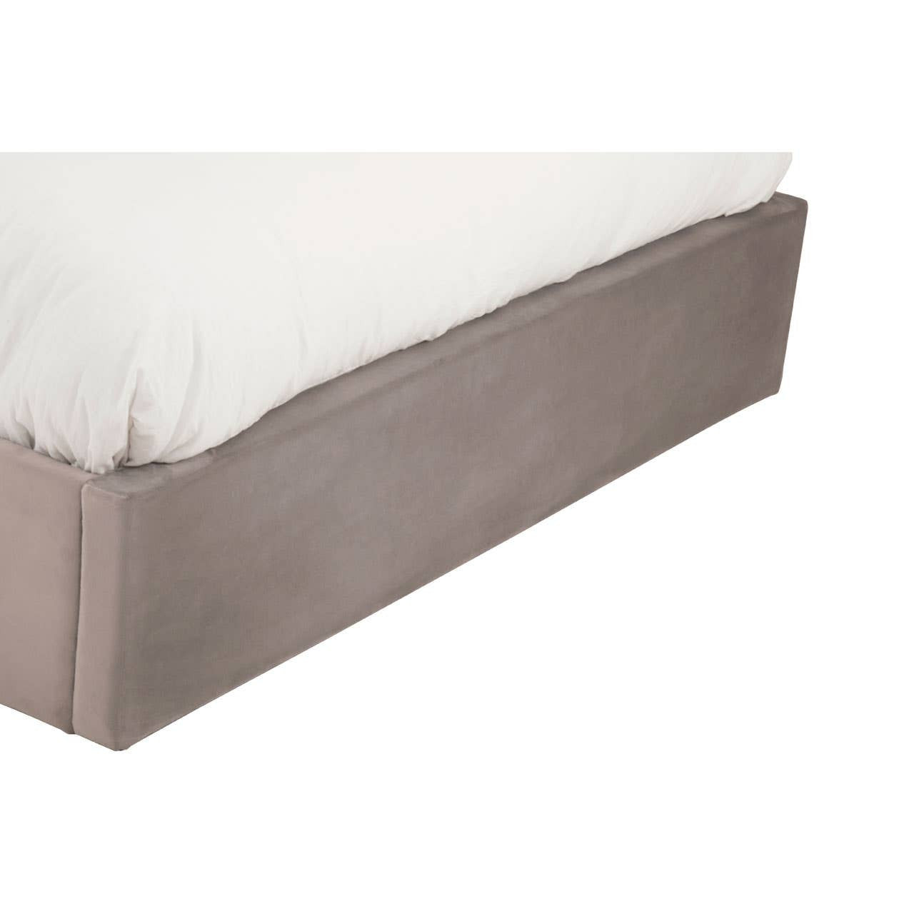 Grey upholstered ottoman king bed with a soft, padded headboard and a sleek, minimalist design. The bed features a low-profile base covered in a textured grey fabric, complemented by a plush white mattress on top