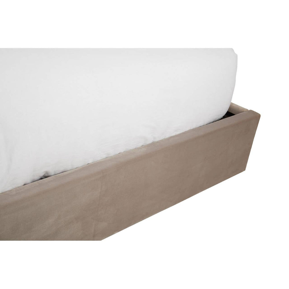 Mink velvet upholstered king bed with a sleek, modern design featuring a soft, cushioned headboard and a sturdy wooden base in a light brown finish. The bed includes a spacious storage compartment underneath, partially visible, showcasing a white mattress resting on top