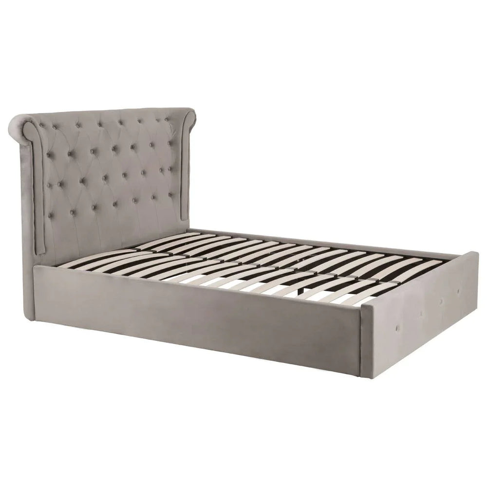 Grey upholstered bed frame with tufted headboard and wood slats, angled side view