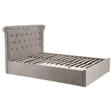 Grey upholstered bed frame with tufted headboard and wood slats, angled side view