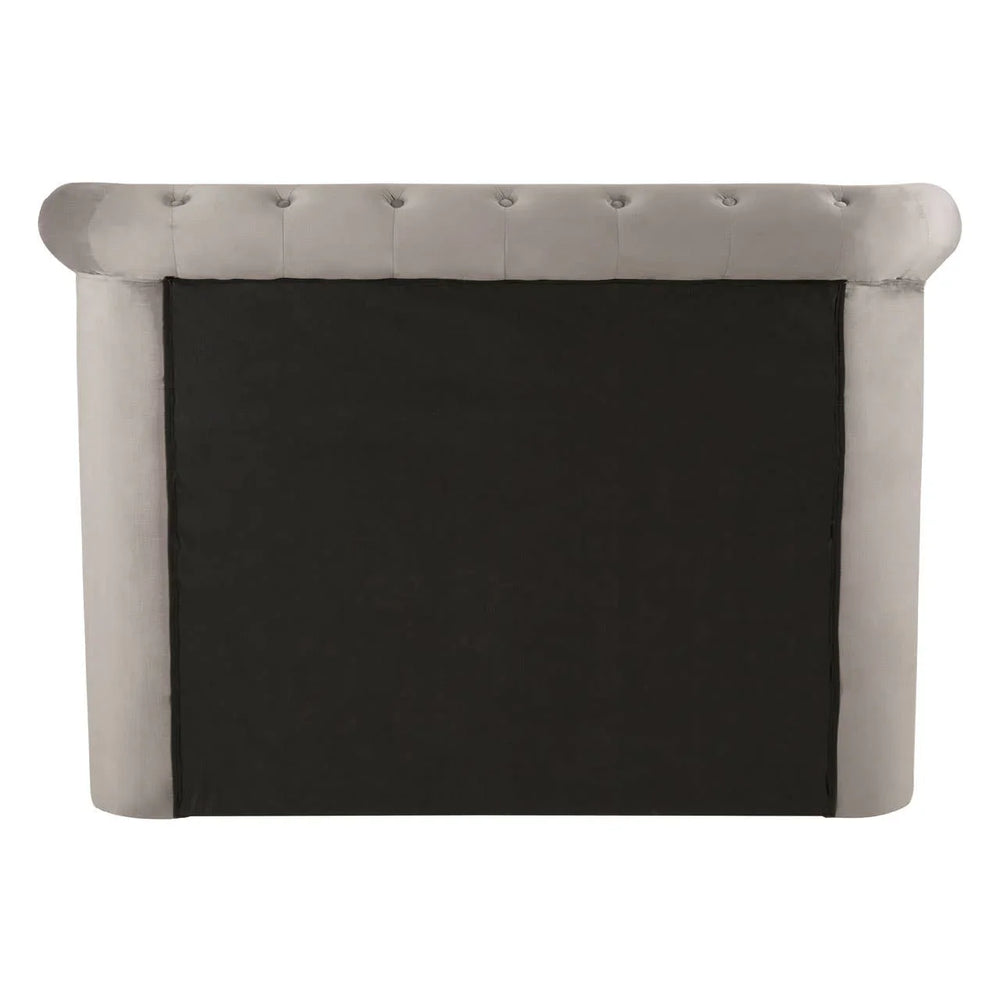 Rear view of grey upholstered bed headboard with black fabric backing and button details