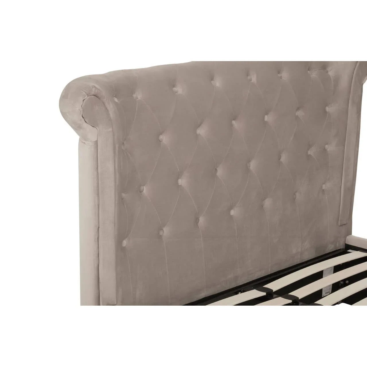 Tufted velvet bed frame headboard in light beige with diamond button detail, side angle view