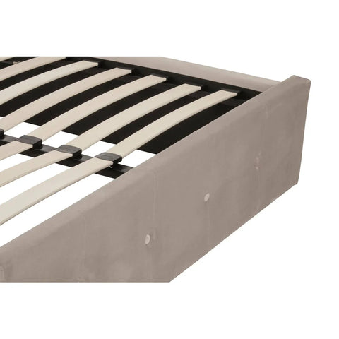 Closeup of upholstered bed frame with wooden slats and button tufting detail
