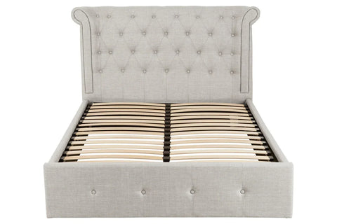 Grey upholstered bed frame with button tufted headboard and wooden slats, front view