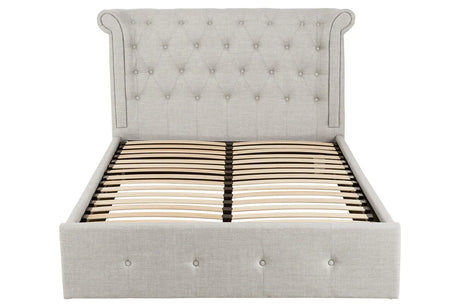 Grey upholstered bed frame with button tufted headboard and wooden slats, front view
