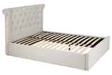 Light grey upholstered bed frame with tufted headboard and wooden slats, angled view