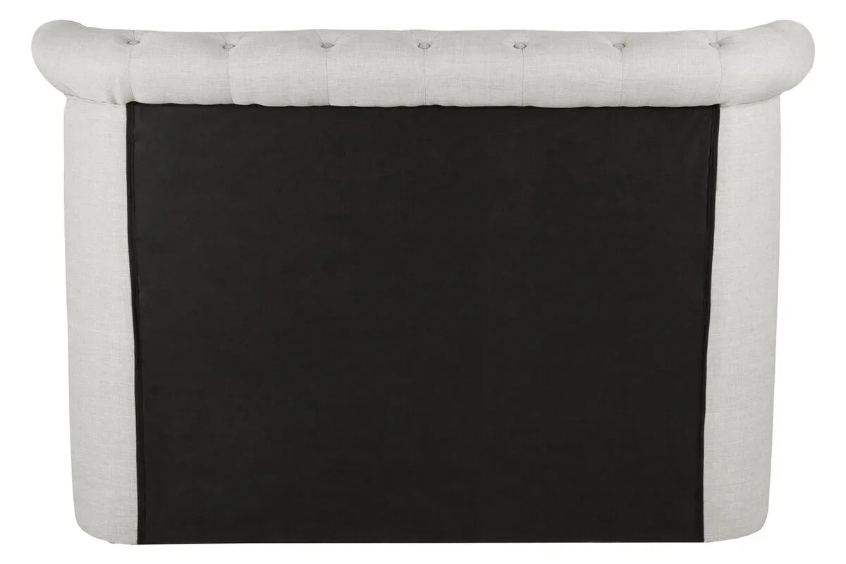 Back view of tufted fabric sofa with light upholstery and black panel detail