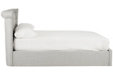 Side view of grey upholstered bed frame with white bedding and pillow