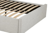 Light grey upholstered bed frame with wooden slats and low padded headboard, close view
