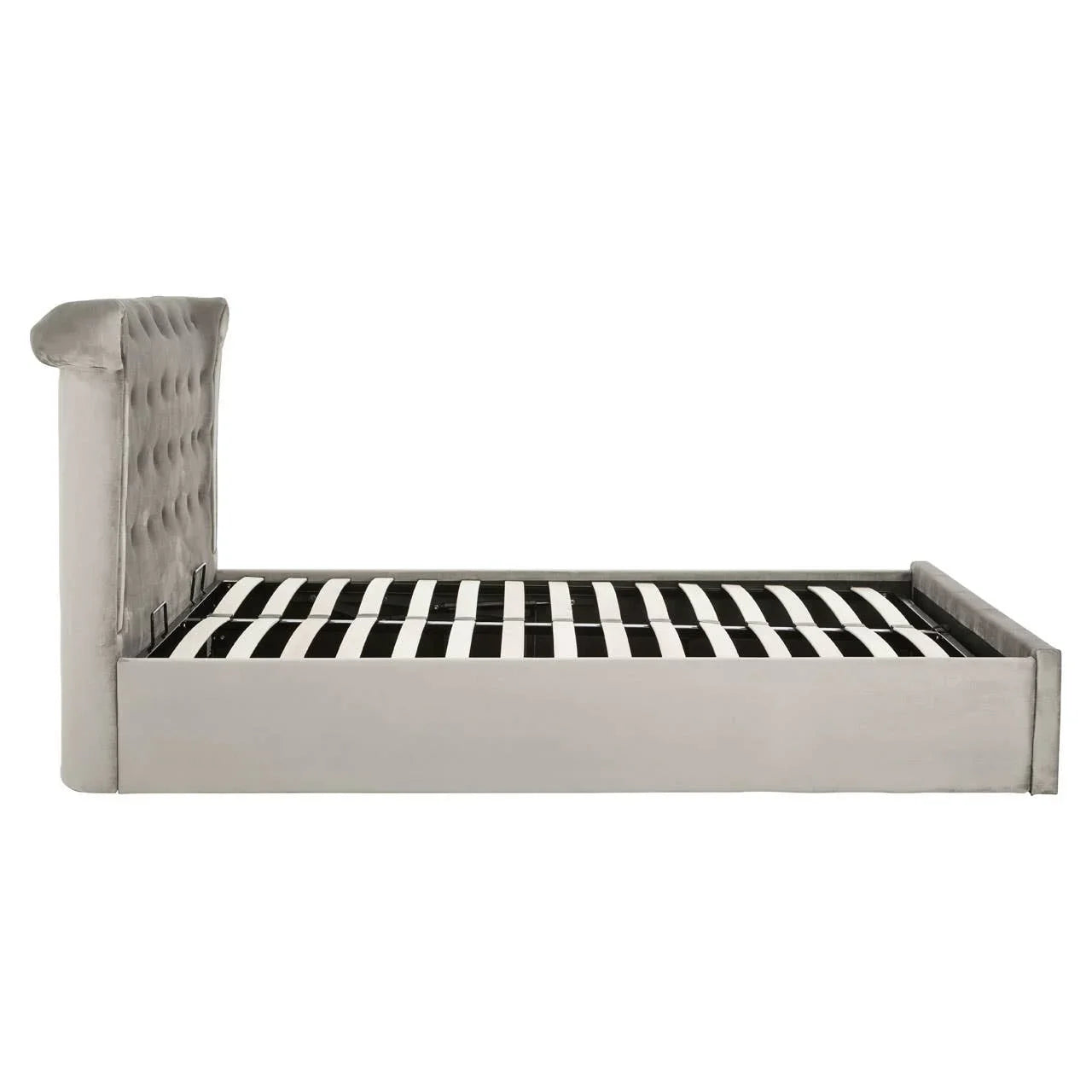 Side view of grey upholstered bed frame with tall tufted headboard and slatted base
