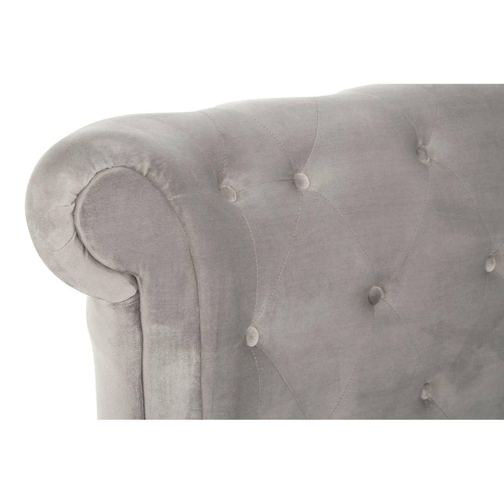 Grey velvet sofa armrest with button-tufted upholstery, close up on rolled detail