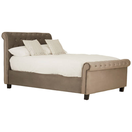 Grey ottoman double bed with a tufted headboard, featuring two decorative cushions and a plush white mattress, resting on short black legs. The bed has a sleek, modern design with a soft fabric upholstery
