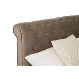 Grey upholstered headboard with tufted detailing and a soft fabric finish, accompanied by a decorative cream-colored pillow resting on the bed