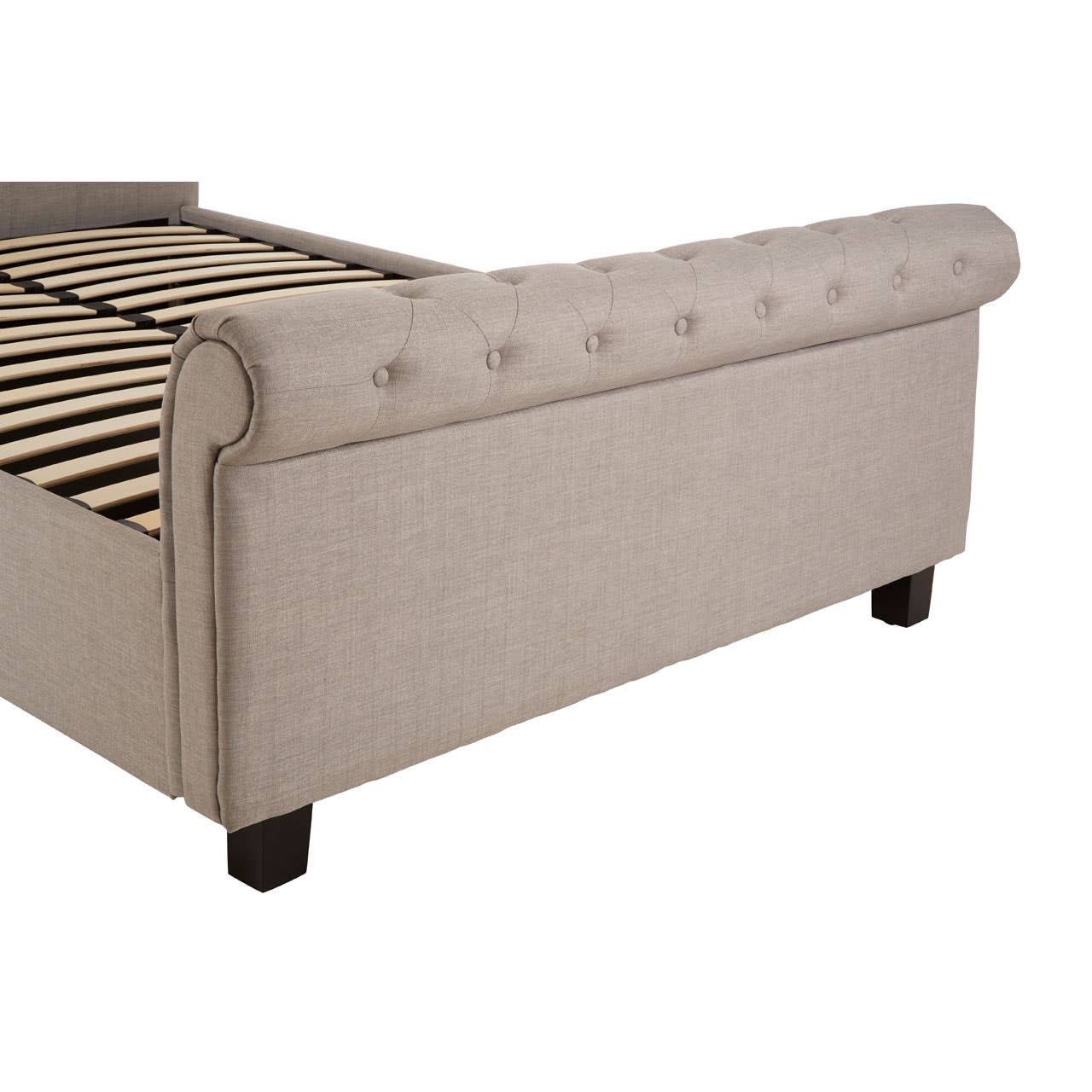 Light grey upholstered ottoman double bed featuring a tufted headboard, wooden legs, and a slatted base. The design includes a curved backrest and a storage compartment accessible from the top