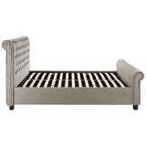 Grey ottoman king bed featuring a tufted headboard and side rails, with a slatted base for mattress support, set on short black legs
