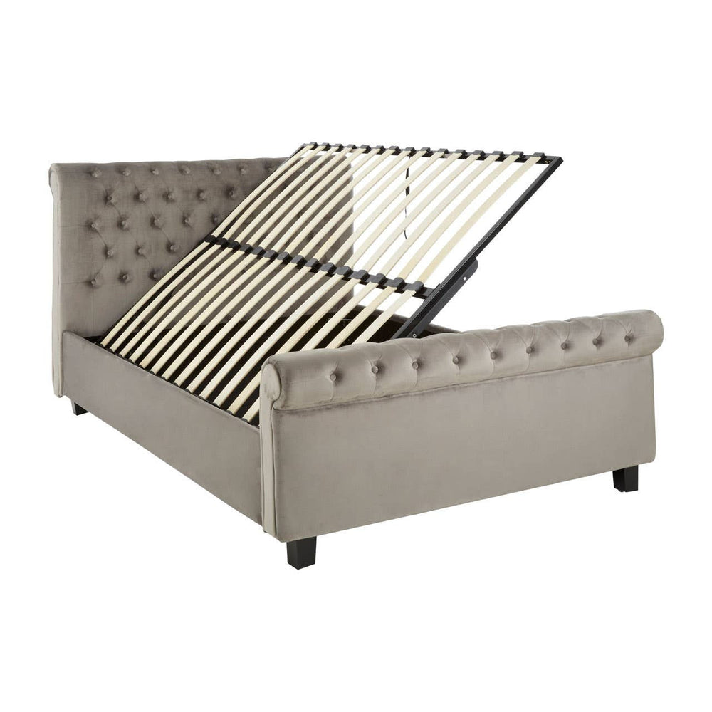 Grey upholstered king bed with a tufted headboard and a storage compartment that lifts up, revealing wooden slats underneath. The bed is supported by four black legs and features a contemporary design suitable for modern home decor