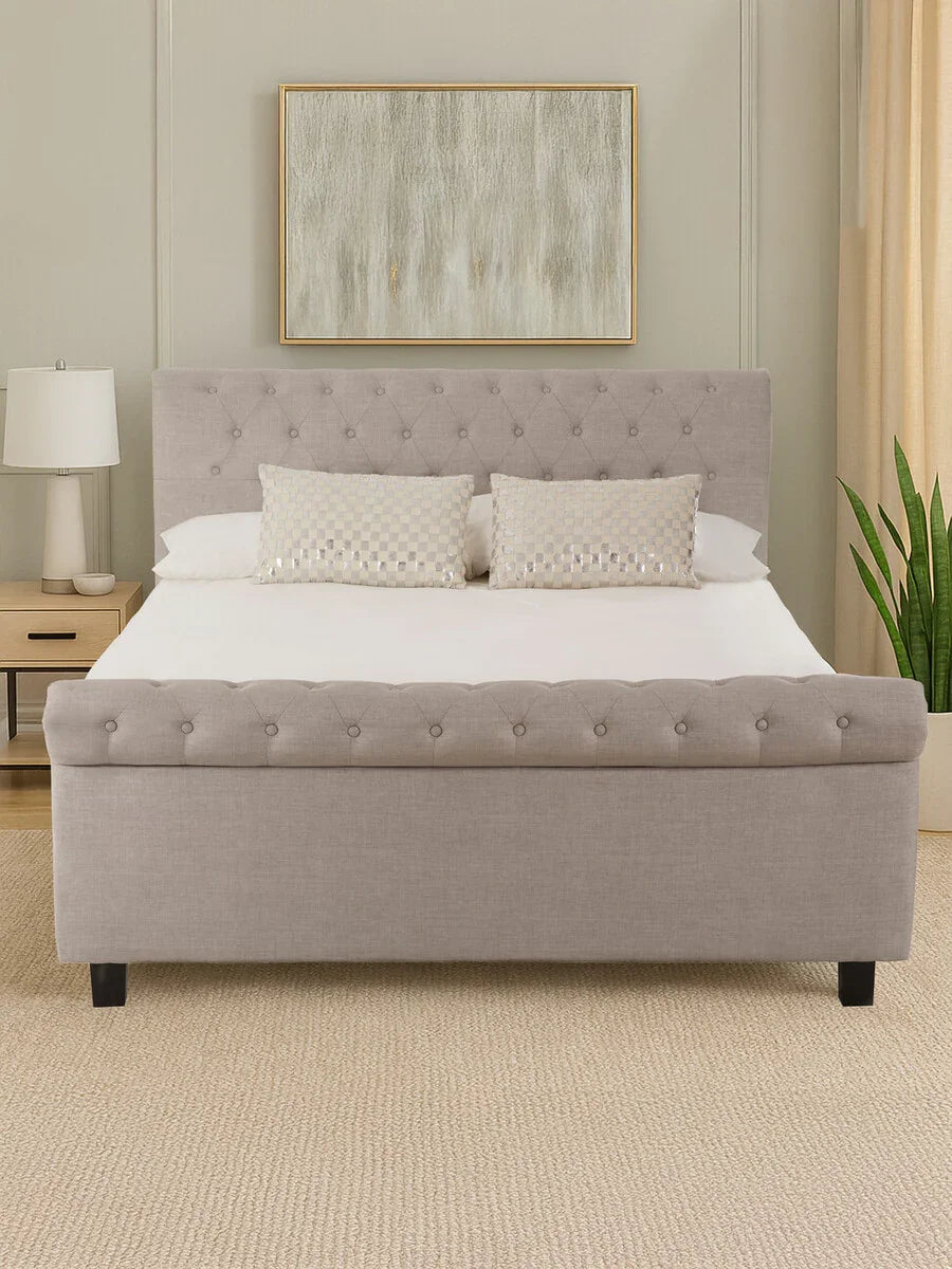 Light grey upholstered bed with button tufted headboard and footboard in modern bedroom