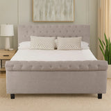 Light grey upholstered bed frame with button tufting in modern bedroom setting