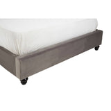 Double bed with a steel shade upholstered base, featuring a low profile and four wheels for easy mobility. The bed is dressed with a white mattress and has a clean, modern design suitable for various bedroom styles