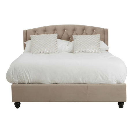 A double bed upholstered in mink brushed velvet with a tufted headboard, featuring two decorative pillows and a white bedding set, resting on dark wooden legs