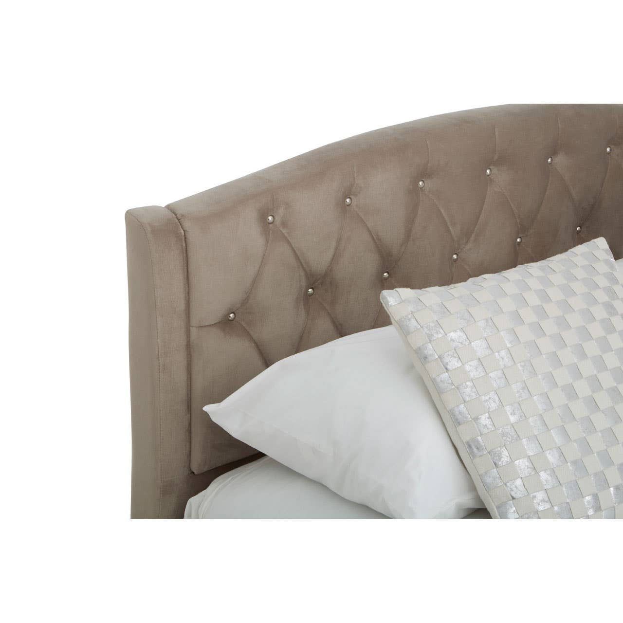 Mink brushed velvet headboard with tufted detailing and decorative buttons, accompanied by a white pillow and a patterned cushion, showcasing a cozy and elegant bedding arrangement
