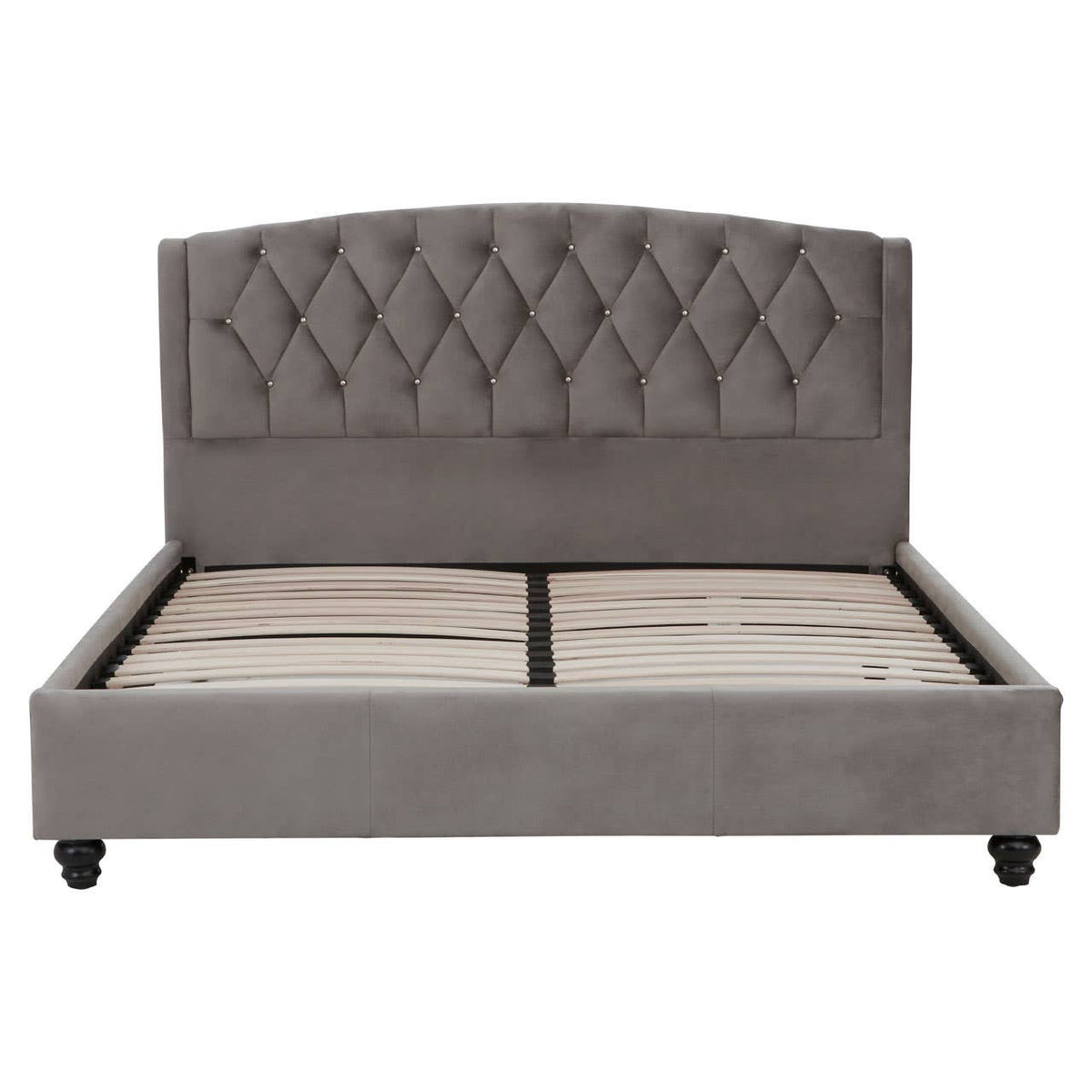 Grey velvet king bed with a tufted headboard and a low-profile frame, featuring storage space underneath. The bed stands on four wooden legs, showcasing a modern and elegant design suitable for a stylish bedroom