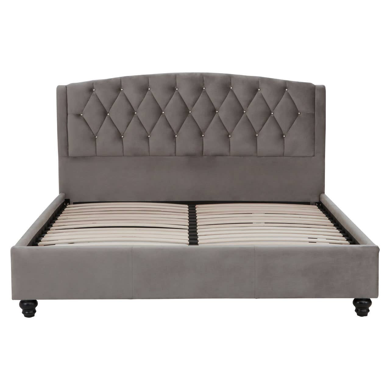 Grey velvet king bed with a tufted headboard and a low-profile frame, featuring storage space underneath. The bed stands on four wooden legs, showcasing a modern and elegant design suitable for a stylish bedroom