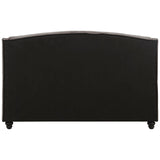 Grey velvet king bed with a curved headboard and tapered legs, showcasing a soft texture and elegant design
