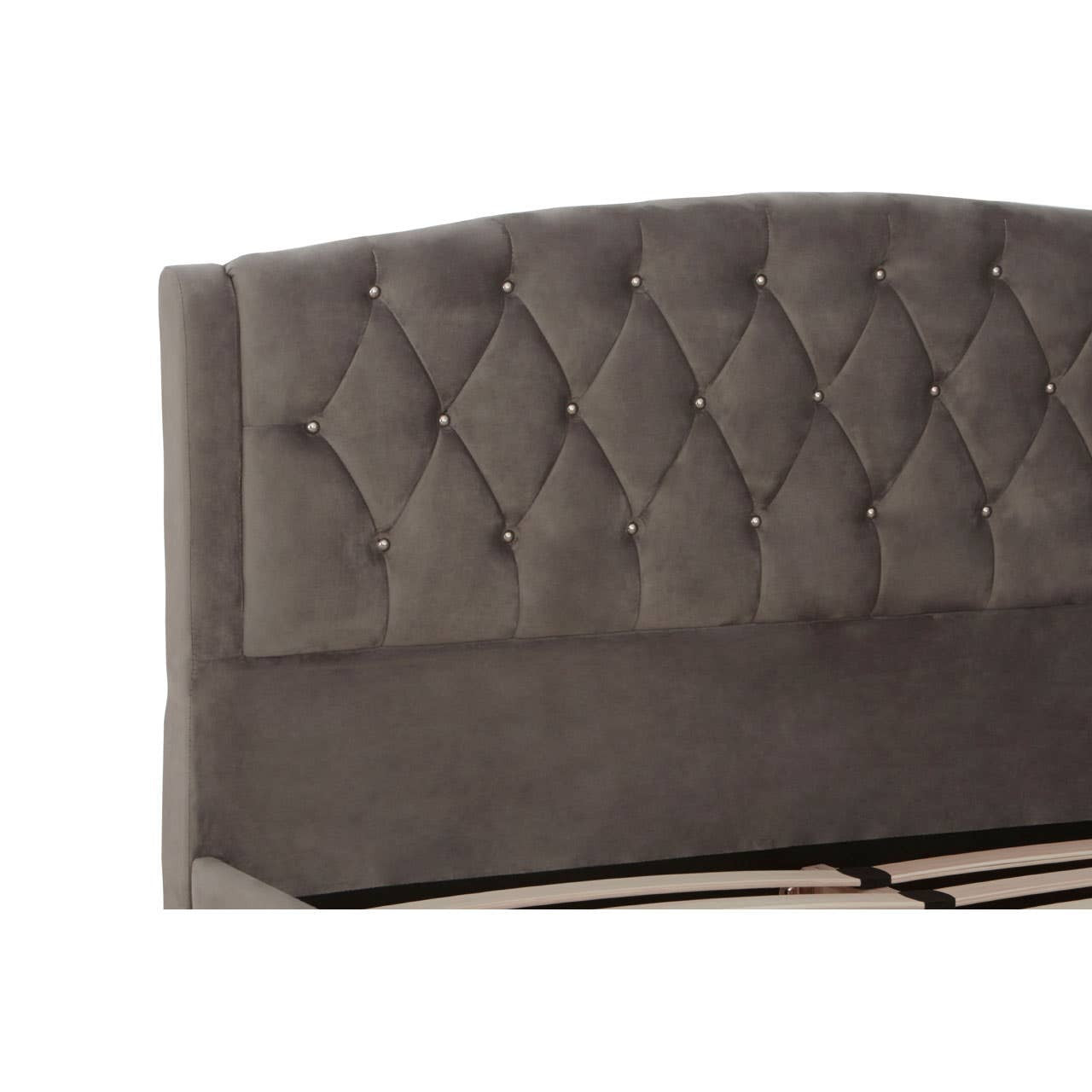 Grey velvet headboard with a tufted design featuring diamond-shaped patterns, showcasing a soft and luxurious texture. The headboard is slightly arched at the top, adding an elegant touch to the overall design