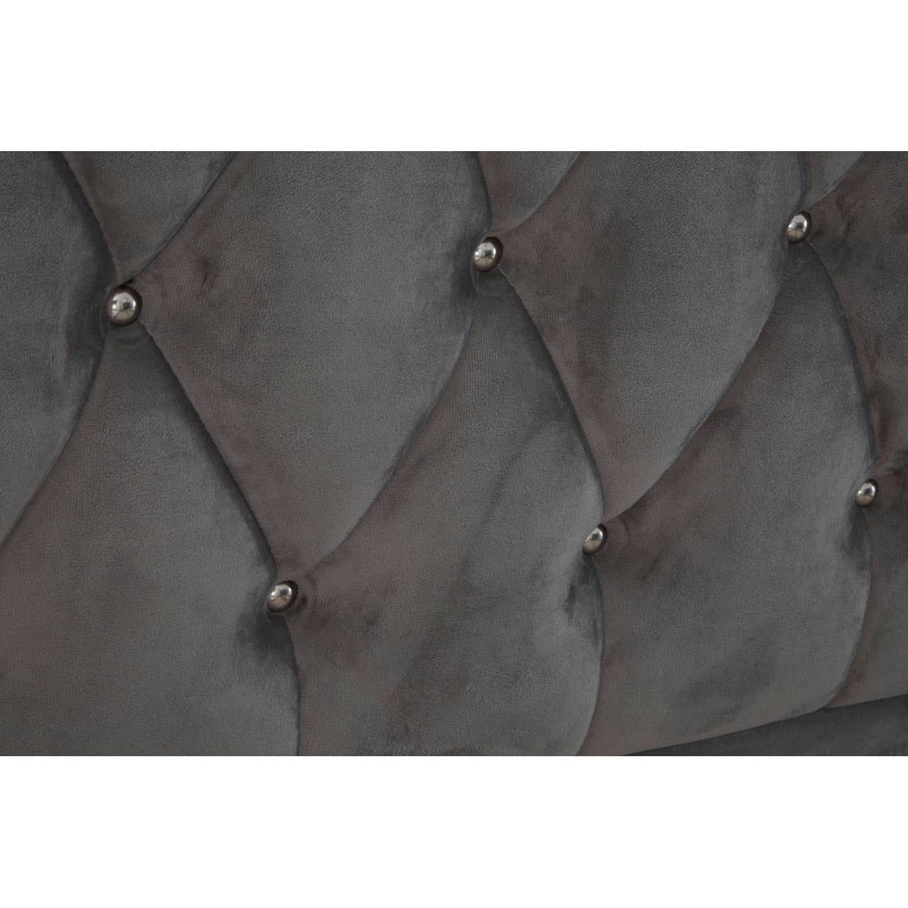 Grey velvet upholstery with a tufted design featuring diamond patterns and decorative buttons, showcasing a luxurious texture suitable for a king-sized bed