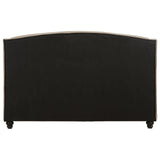 Back view of upholstered bed frame with black fabric panel and turned wooden legs
