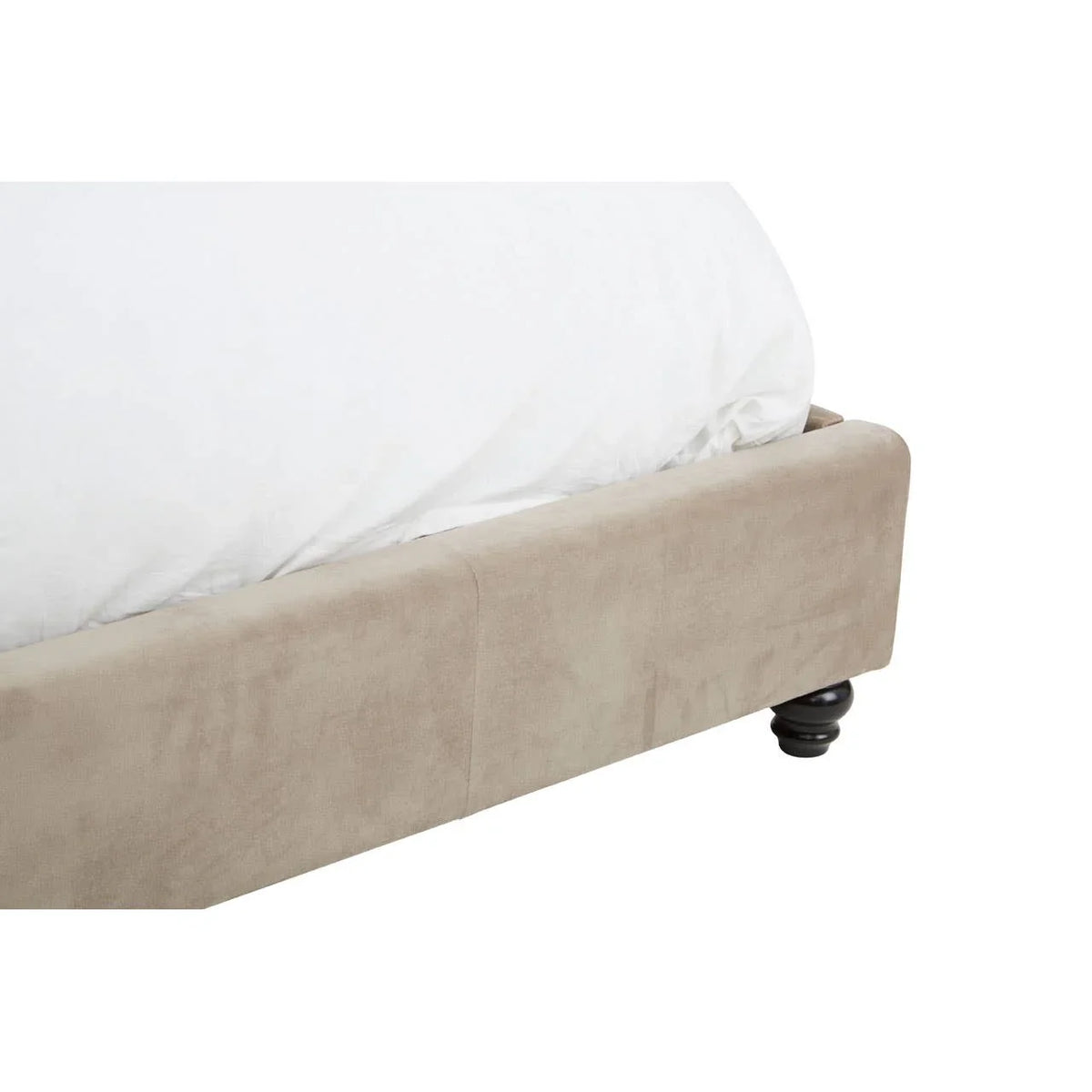 Beige upholstered bed frame corner with wooden turned leg and white bedding