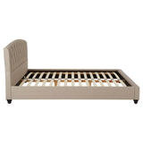 Beige king bed with a padded headboard and wooden slats for mattress support, featuring tapered legs and a minimalist design