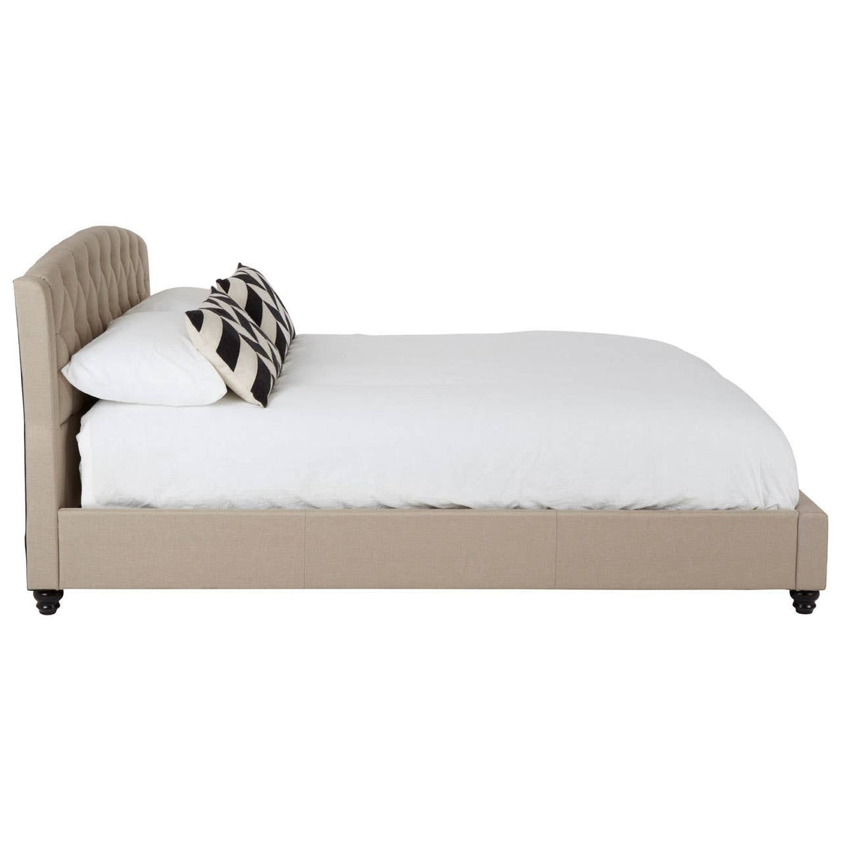 Beige king bed with a curved headboard, featuring a white mattress and a decorative pillow, resting on dark wooden legs