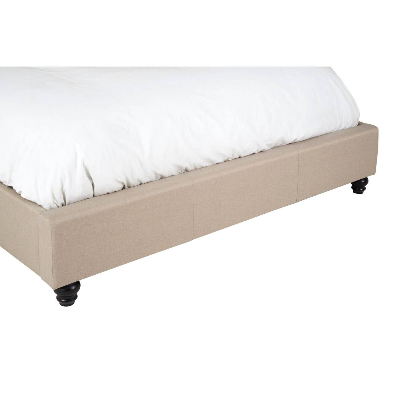 Beige king bed with a low-profile design, featuring a soft upholstered base and four round black wheels for easy mobility, partially covered by a white comforter