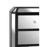 Corner view of mirrored chest of drawers with crystal handles and black trim
