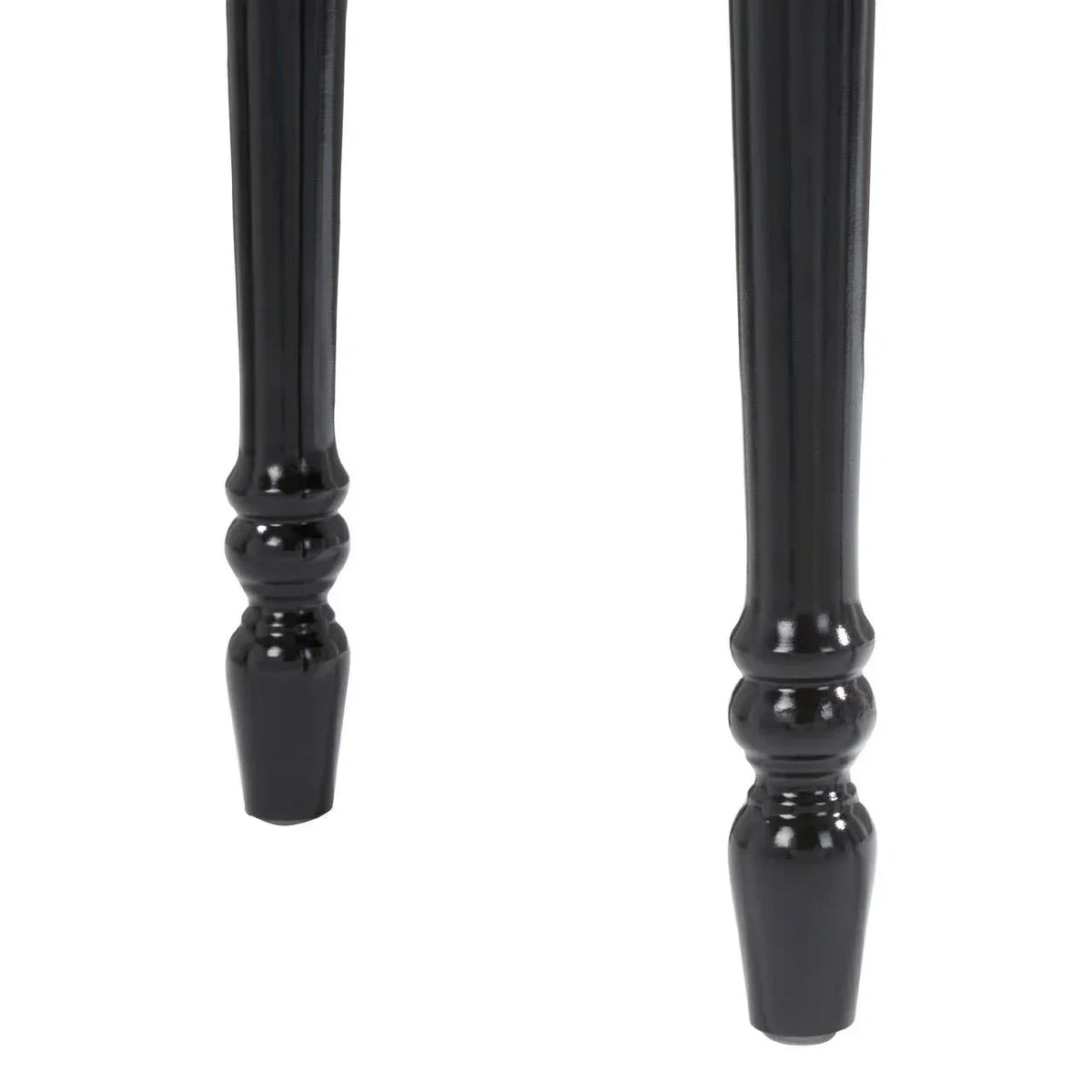 Black turned wood table legs with glossy finish, close-up view of leg detailing