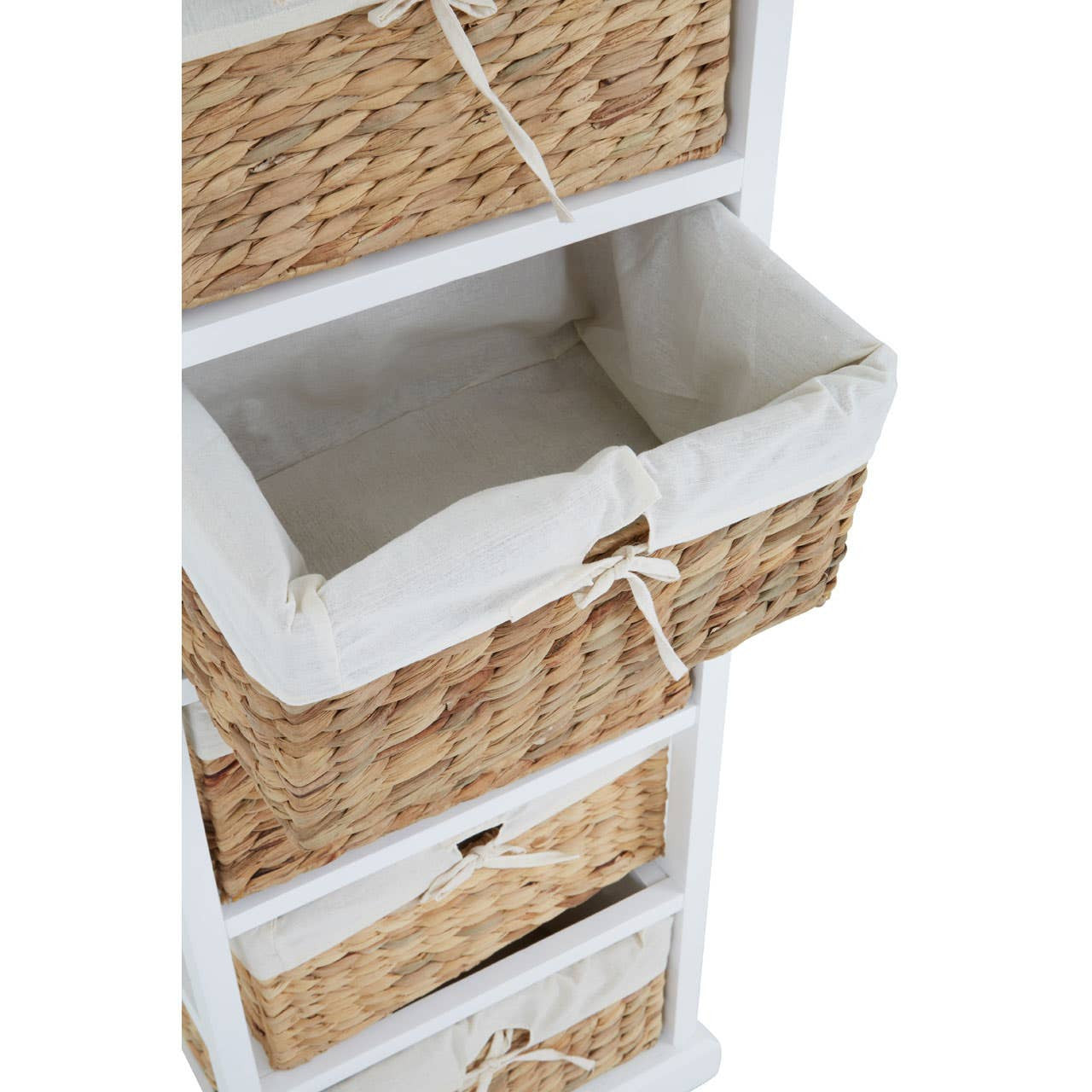 A white wooden chest featuring five woven seagrass drawers, with the top drawer partially open to reveal a fabric lining. The chest has a clean, modern design suitable for home decor