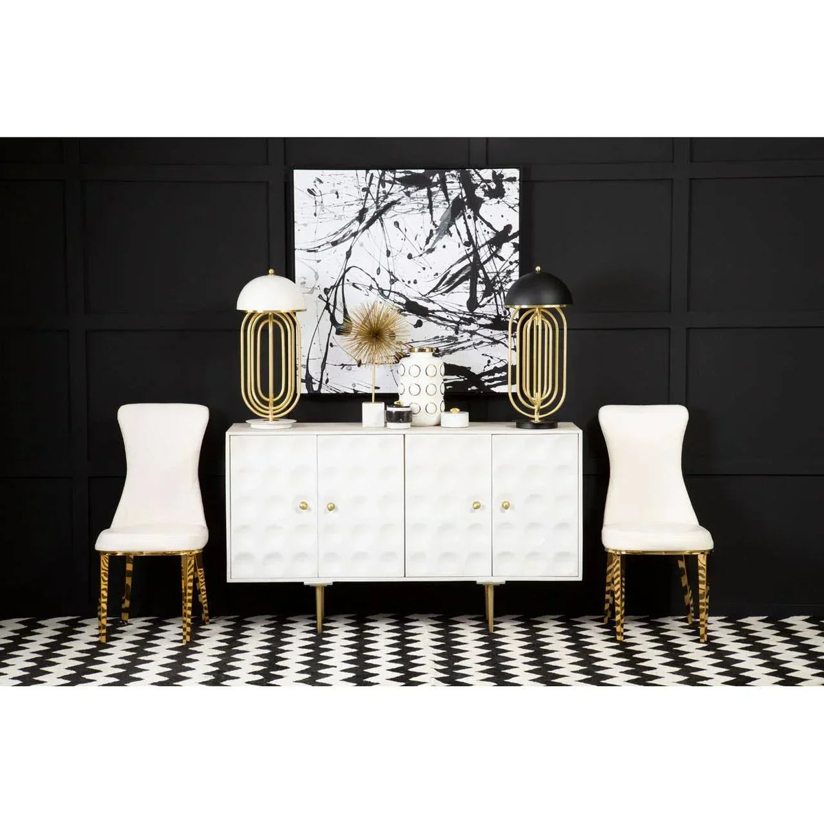 Modern white sideboard with geometric doors, gold lamps, accent chairs and abstract wall art