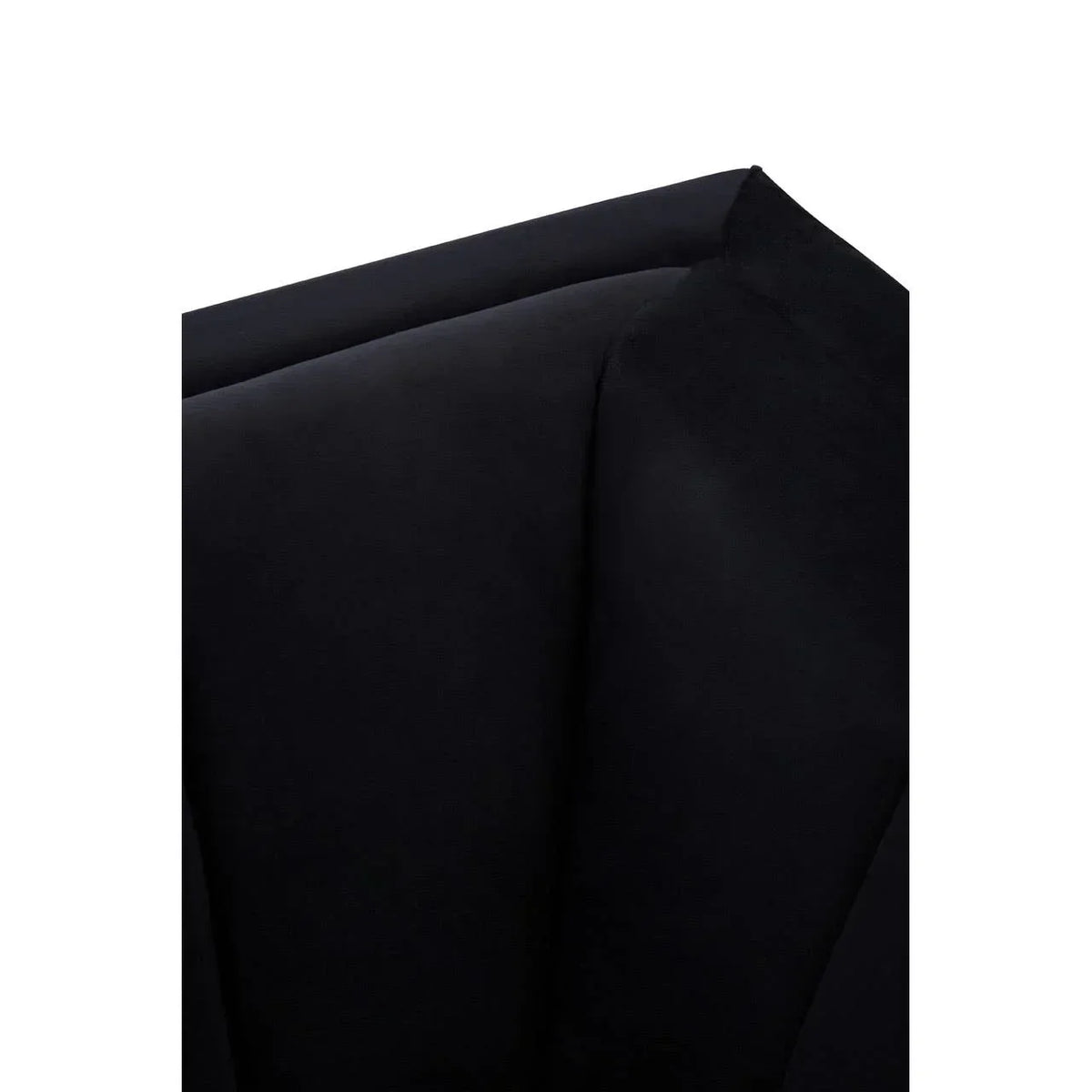 Close-up of black velvet armchair backrest with tufted cushion detail