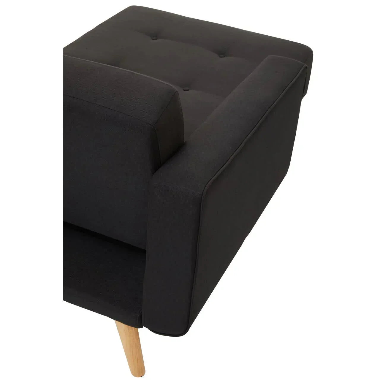 Closeup of black fabric sofa arm with button-tufted seat and wooden leg