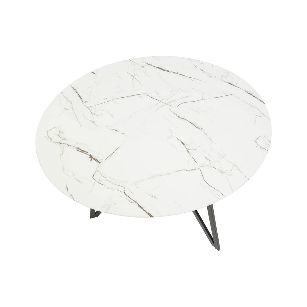 Round dining table with a white marble effect top featuring subtle gray veining, supported by sleek black metal legs. The set includes six matching chairs with a modern design, each featuring a cushioned seat and backrest for comfort