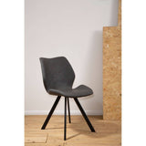Round dining table with a marble effect surface, surrounded by six stylish chairs featuring a modern design and black legs. The setting includes a light wooden floor and a neutral wall backdrop, creating a contemporary dining atmosphere
