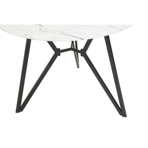 Round dining table with a white marble effect top and a modern black metal base featuring angular legs, accompanied by six matching chairs with a sleek design