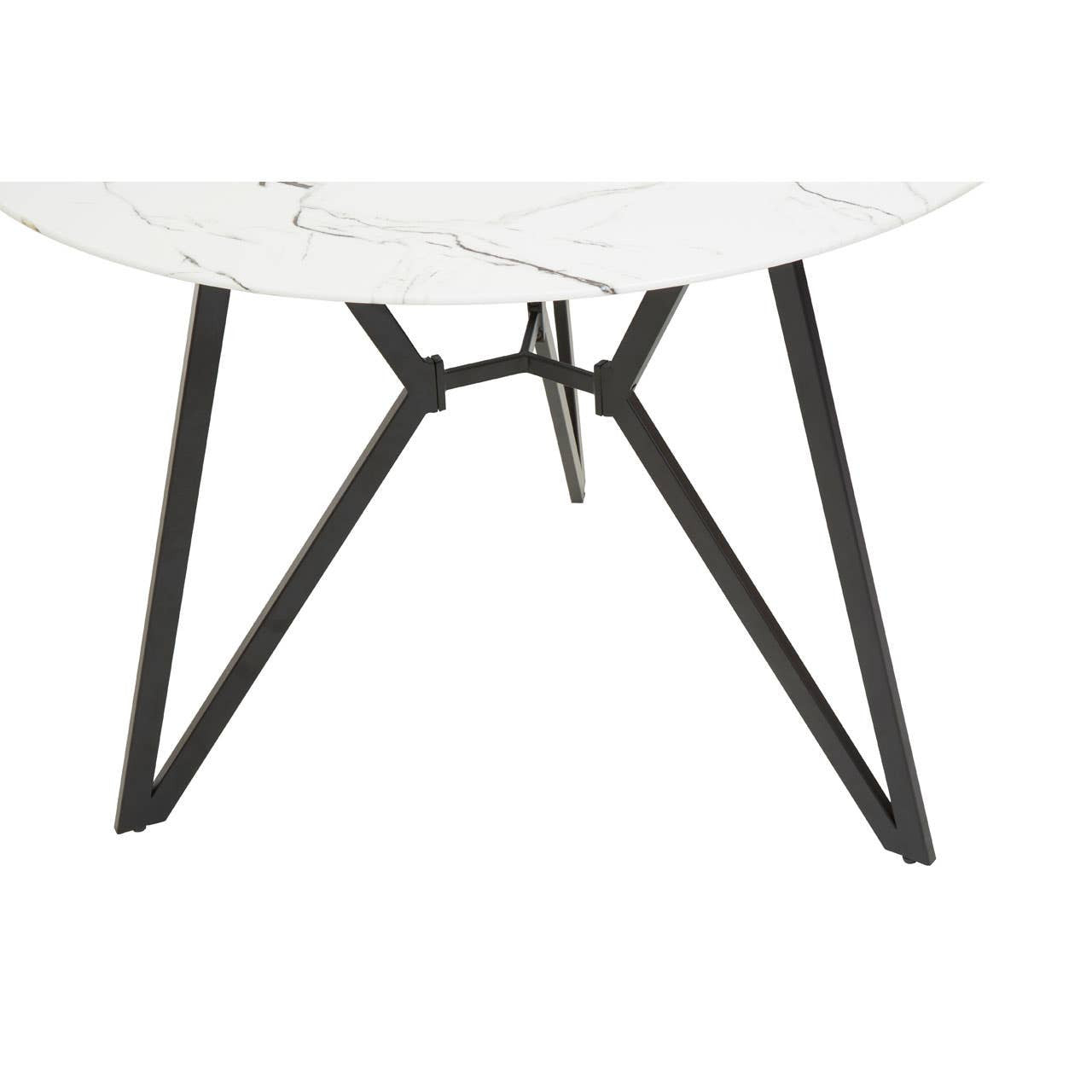 Round dining table with a white marble effect top and a modern black metal base featuring angular legs, accompanied by six matching chairs with a sleek design