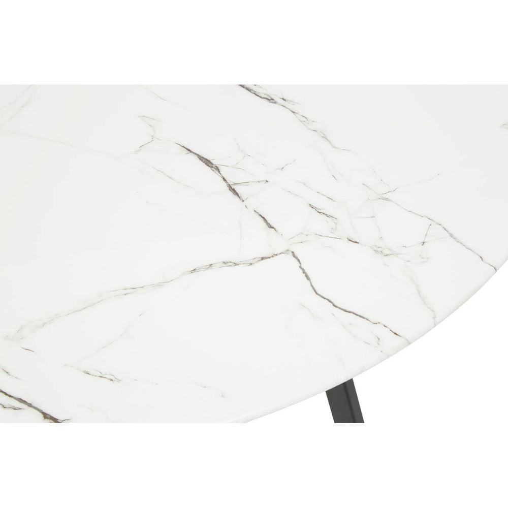 Round dining table featuring a white marble effect surface with subtle gray veining, supported by a sleek black base. The image focuses on the tabletop, highlighting its smooth finish and elegant design