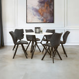 Round dining table with a marble effect top surrounded by six upholstered chairs with dark frames, set in a modern dining area featuring a neutral color palette and a large abstract artwork on the wall. The floor is light-colored, enhancing the contemporary aesthetic of the space