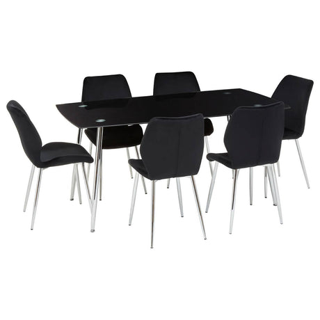 Black tempered glass dining table accompanied by six matching black upholstered chairs with sleek metal legs, arranged around the table in a modern setting